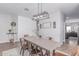 Cozy dining room featuring a rustic chandelier and views into the kitchen and living areas at 681 W Belmont Red Trl, San Tan Valley, AZ 85143