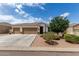 Charming single-story home featuring a three-car garage, desert landscaping and mature shade trees at 681 W Belmont Red Trl, San Tan Valley, AZ 85143