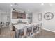 Bright kitchen featuring an island with barstool seating, stainless steel appliances, and ample storage at 681 W Belmont Red Trl, San Tan Valley, AZ 85143