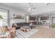 Open-concept living room featuring modern furnishings and an adjacent kitchen with stainless steel appliances at 681 W Belmont Red Trl, San Tan Valley, AZ 85143