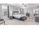 Spacious main bedroom featuring carpet floors, large windows, and gray furniture at 681 W Belmont Red Trl, San Tan Valley, AZ 85143