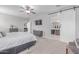 This main bedroom includes a gray dresser, a ceiling fan, and a doorway into the main bathroom at 681 W Belmont Red Trl, San Tan Valley, AZ 85143