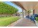 The backyard features a patio, green lawn, shade trees, and a seating area at 6870 S Justin Way, Chandler, AZ 85249