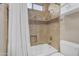 Bathroom with combined shower and bath area, beige wall tile and decorative accent tiles at 6870 S Justin Way, Chandler, AZ 85249