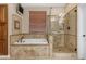 Elegant bathroom featuring a separate soaking tub and shower with decorative tile work and updated fixtures at 6870 S Justin Way, Chandler, AZ 85249