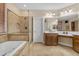 Luxurious bathroom featuring a soaking tub, separate shower, and dual sinks with generous counter space at 6870 S Justin Way, Chandler, AZ 85249