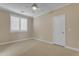 Bright bedroom featuring carpet, neutral paint, and window with shutters and a ceiling fan at 6870 S Justin Way, Chandler, AZ 85249