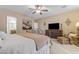 Bright bedroom featuring a decorative wrought iron bed frame, television, and comfortable sitting area at 6870 S Justin Way, Chandler, AZ 85249
