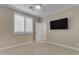 Neutral bedroom with a ceiling fan and a mounted television at 6870 S Justin Way, Chandler, AZ 85249