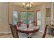 Cozy breakfast nook with a round table, four chairs, and a bay window with a view at 6870 S Justin Way, Chandler, AZ 85249