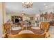 Open dining area with chandelier, wood table set, and views of the kitchen and living room at 6870 S Justin Way, Chandler, AZ 85249