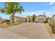 Beautiful single-story home boasts a circular driveway, desert landscaping, and a three-car garage at 6870 S Justin Way, Chandler, AZ 85249