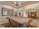 Spacious game room featuring a billiard table, elegant lighting, and classic decor at 6870 S Justin Way, Chandler, AZ 85249