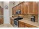 Gourmet kitchen with stainless steel appliances, stylish backsplash, and custom wood cabinetry at 6870 S Justin Way, Chandler, AZ 85249