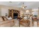 Spacious living room with comfortable seating, a ceiling fan, and a large entertainment center at 6870 S Justin Way, Chandler, AZ 85249