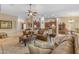 Open-concept living room flows into the kitchen featuring a ceiling fan and lots of natural light at 6870 S Justin Way, Chandler, AZ 85249