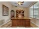 Office room features a large executive desk, decorative shelving, natural light from the window, and neutral colors at 6870 S Justin Way, Chandler, AZ 85249