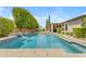 Sparkling pool featuring a waterfall, well-manicured landscaping, and covered patio creating an ideal outdoor oasis at 6870 S Justin Way, Chandler, AZ 85249