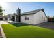 Large backyard with artificial turf, patio, and an exterior of a modern home at 7425 W Corrine Dr, Peoria, AZ 85381