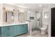 Modern bathroom featuring a blue double sink vanity, marble tile, and a glass enclosed shower at 7425 W Corrine Dr, Peoria, AZ 85381