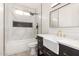 Nicely updated bathroom featuring a vanity, white tiling, shower, modern fixtures, and stylish design at 7425 W Corrine Dr, Peoria, AZ 85381