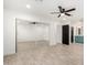 Bedroom featuring a mirrored closet, wood look floors, ceiling fan, and an adjacent bathroom with blue cabinets at 7425 W Corrine Dr, Peoria, AZ 85381