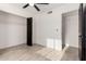 Bedroom featuring wood look floors, a ceiling fan, a closet and a door adding comfort to the area at 7425 W Corrine Dr, Peoria, AZ 85381