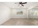 Bright bedroom with ceiling fan, wood look floors, a sliding mirror closet, and a window overlooking the neighborhood at 7425 W Corrine Dr, Peoria, AZ 85381
