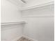 Empty walk-in closet with white shelving, creating an organized storage space at 7425 W Corrine Dr, Peoria, AZ 85381