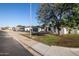 Charming single-story home with a well-maintained front yard, a black garage door, and a red front door at 7425 W Corrine Dr, Peoria, AZ 85381