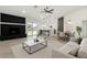 Inviting open-concept living area with a fireplace, kitchen island, and dining space at 7425 W Corrine Dr, Peoria, AZ 85381