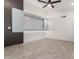 Bright living room featuring a modern wall accent, a ceiling fan, and wood-look tile flooring at 7425 W Corrine Dr, Peoria, AZ 85381