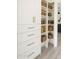 Bright white pantry with pull out drawers and shelves including decor basket and jars for an organized kitchen at 7425 W Corrine Dr, Peoria, AZ 85381