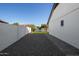 A side yard featuring a low-maintenance desert landscape and white exterior walls at 7425 W Corrine Dr, Peoria, AZ 85381