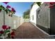 A side yard featuring a low-maintenance desert landscape and white and dark gray exterior walls at 7425 W Corrine Dr, Peoria, AZ 85381