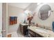 Bathroom featuring dual sinks, granite countertops, and decorative floral arrangements at 7457 W Crystal Rd, Glendale, AZ 85308