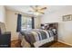 Bedroom with a queen bed, wooden floors, ceiling fan, and blackout curtains at 7457 W Crystal Rd, Glendale, AZ 85308