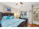 Bright bedroom featuring wood floors, ocean art, and a mirrored closet at 7457 W Crystal Rd, Glendale, AZ 85308