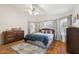 Primary bedroom featuring hardwood floors, a ceiling fan, and natural light at 7457 W Crystal Rd, Glendale, AZ 85308