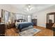 Primary bedroom with a queen bed, ceiling fan, wood floors, and ample dresser storage at 7457 W Crystal Rd, Glendale, AZ 85308