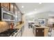 Bright kitchen features granite counters, stainless appliances, and a breakfast bar at 7457 W Crystal Rd, Glendale, AZ 85308