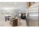 Open kitchen with central island, stainless steel appliances, and view to the adjacent living area at 7457 W Crystal Rd, Glendale, AZ 85308