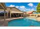 Inviting backyard features a refreshing pool, covered patio, and jacuzzi, perfect for outdoor relaxation and entertaining at 7457 W Crystal Rd, Glendale, AZ 85308