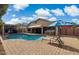 Inviting backyard featuring a sparkling pool, hot tub, outdoor kitchen and patio area at 7457 W Crystal Rd, Glendale, AZ 85308
