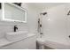 Well-lit bathroom showcasing a vanity, illuminated mirror, black fixtures, and shower-tub combo at 7665 E Montecito Ave, Scottsdale, AZ 85251
