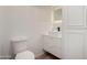 Bright bathroom featuring a toilet, floating vanity, stylish faucet and a decorative tiled wall with a wavy pattern at 7665 E Montecito Ave, Scottsdale, AZ 85251