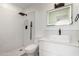 Stylish bathroom with square sink, black fixtures, and shower with black shower head and patterned white tile at 7665 E Montecito Ave, Scottsdale, AZ 85251