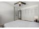 Bright bedroom featuring closet, ceiling fan, and doorway, with wood floors and neutral decor at 7665 E Montecito Ave, Scottsdale, AZ 85251