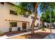 Side view of a charming two-story home with unique architectural details and mature trees at 7665 E Montecito Ave, Scottsdale, AZ 85251