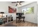 Bright home office with wood floors, large window, and two monitors on desk at 7665 E Montecito Ave, Scottsdale, AZ 85251